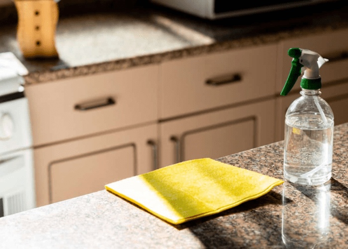 cleaning with water and detergent to remove stains from granite counter