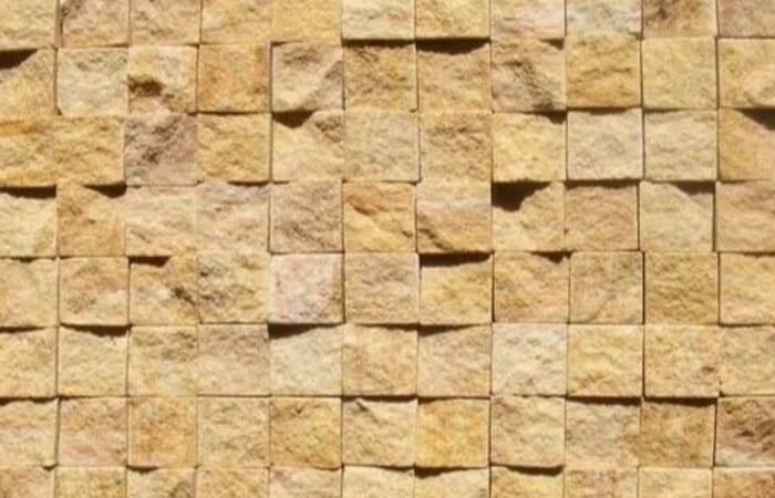 mosaic studded stone wall